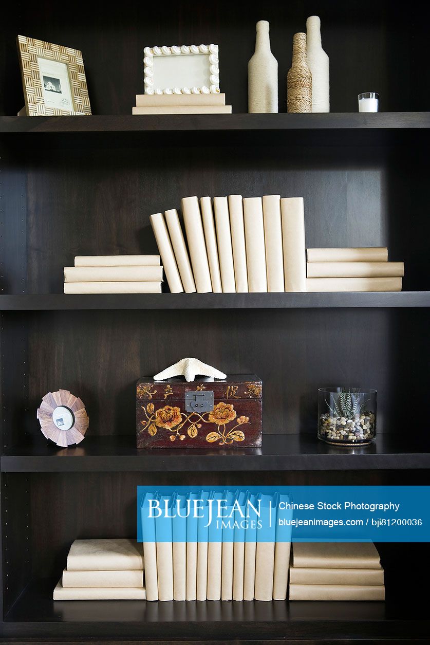 Blank books and decorations on wooden bookshelf