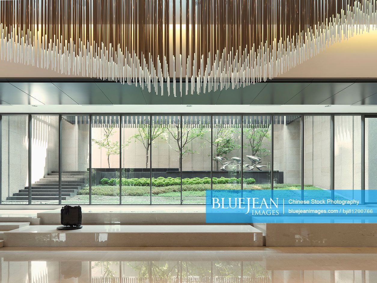 Modern lobby with floor to ceiling windows and decorative ceiling poles