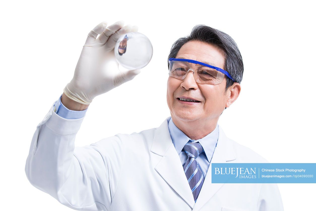 Chinese Scientist examining a transparent ball