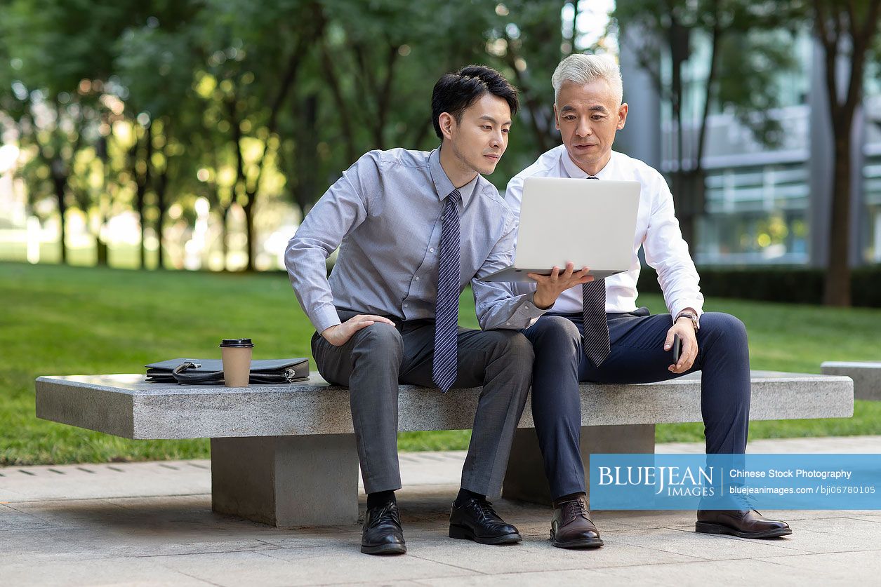 Chinese business people having a meeting outdoors