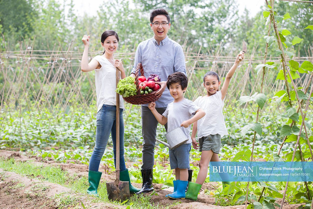 Young Chinese family gardening together