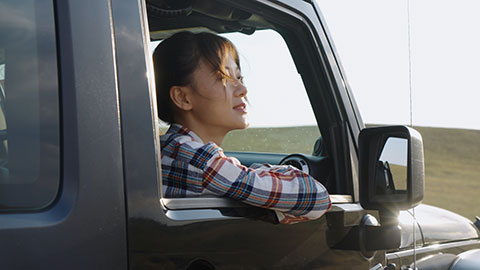 Happy young Chinese woman looking out of car window,4K