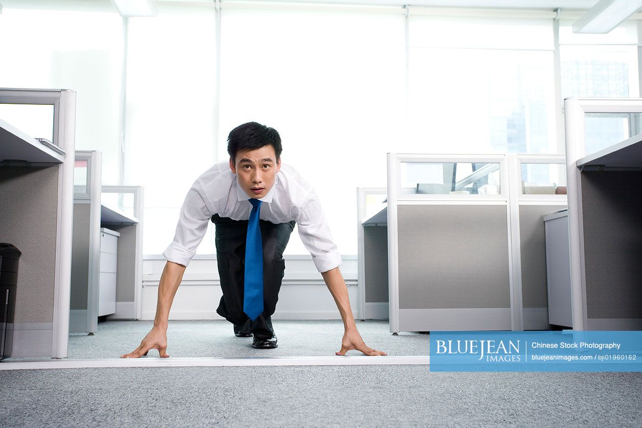 Chinese office worker ready to run in the office