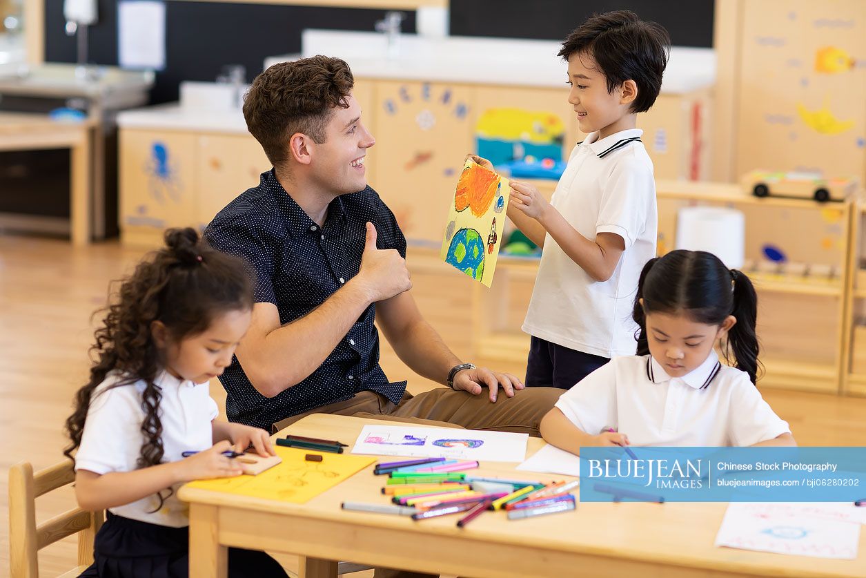 Foreign teacher teaching art class in classroom