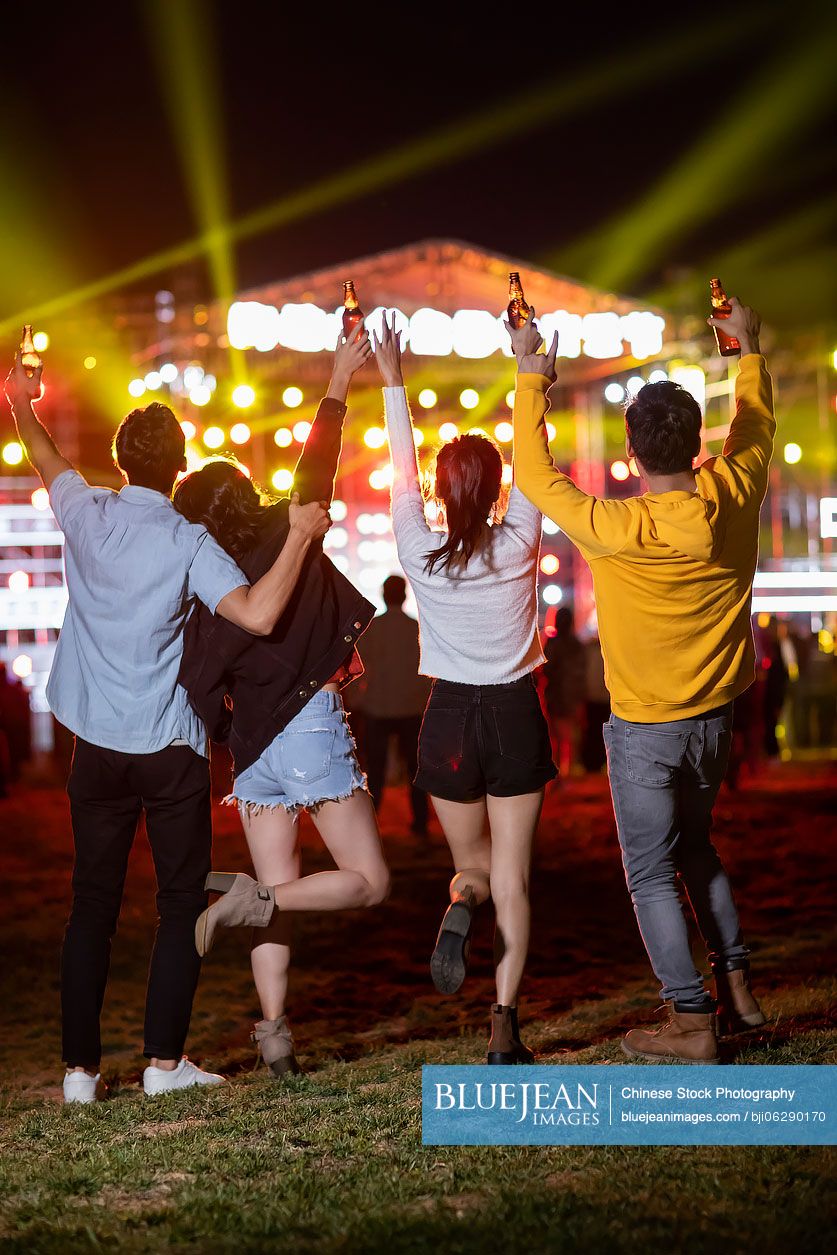 Happy young Chinese friends at music festival