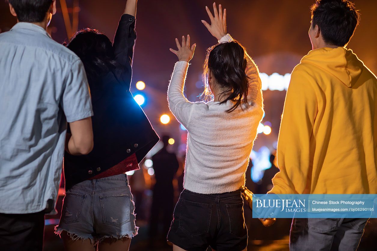 Happy young Chinese friends at music festival