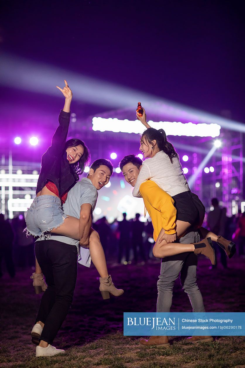 Happy young Chinese friends at music festival