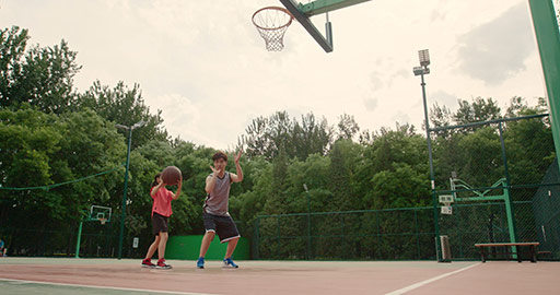 Chinese father and daughter playing basketball in park,4K