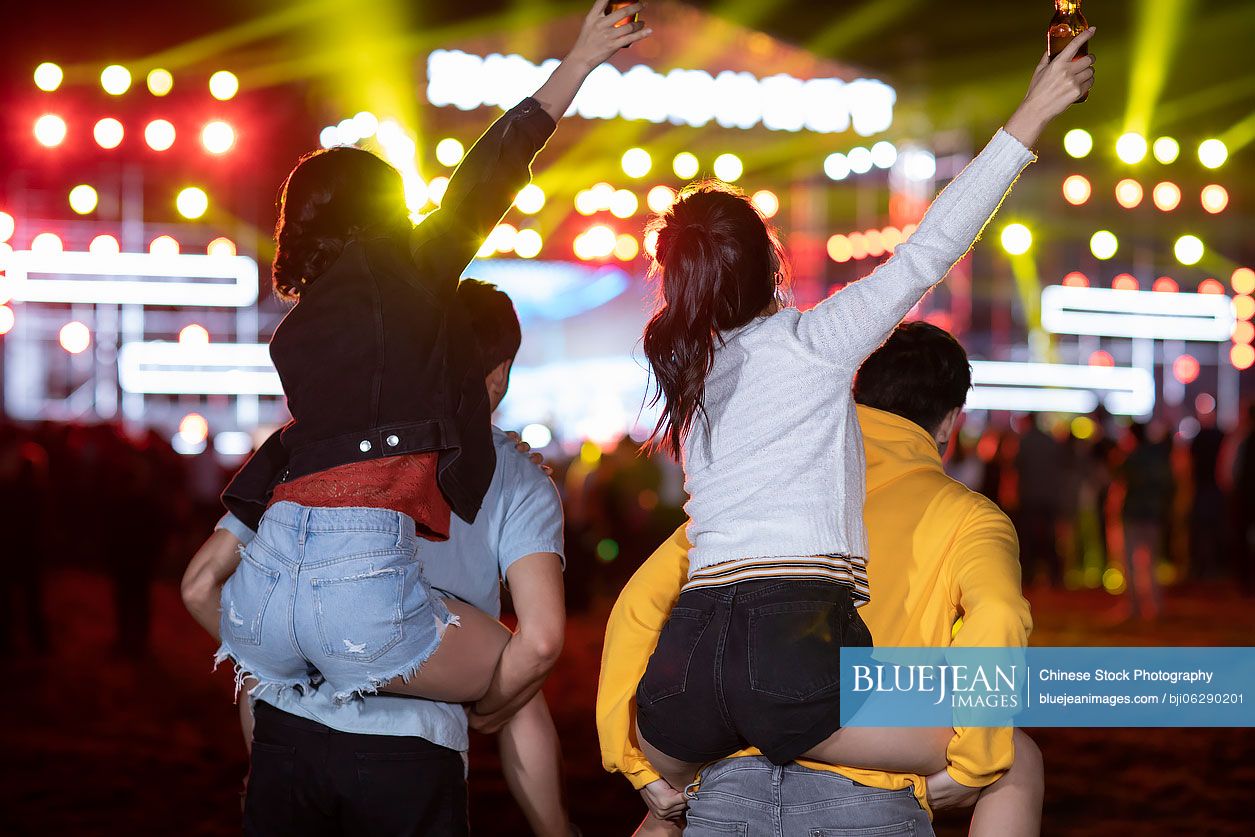 Happy young Chinese friends at music festival