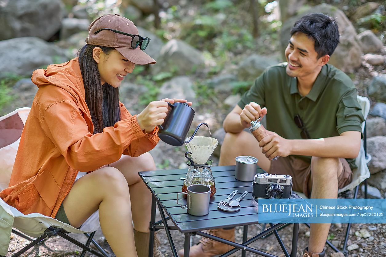 Happy couple sipping tea and enjoying the tranquil surroundings