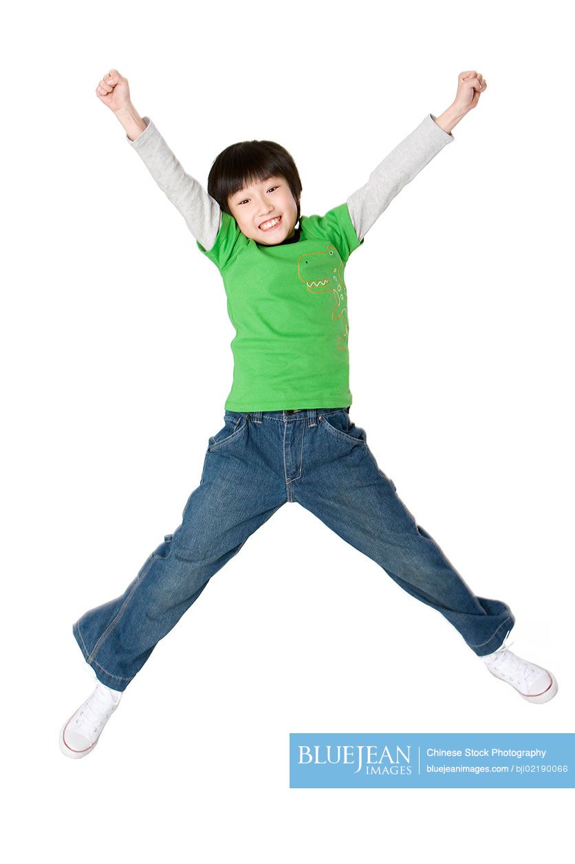 Young Chinese boy jumping up with excitement