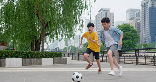 Chinese boys playing football outdoors,4K