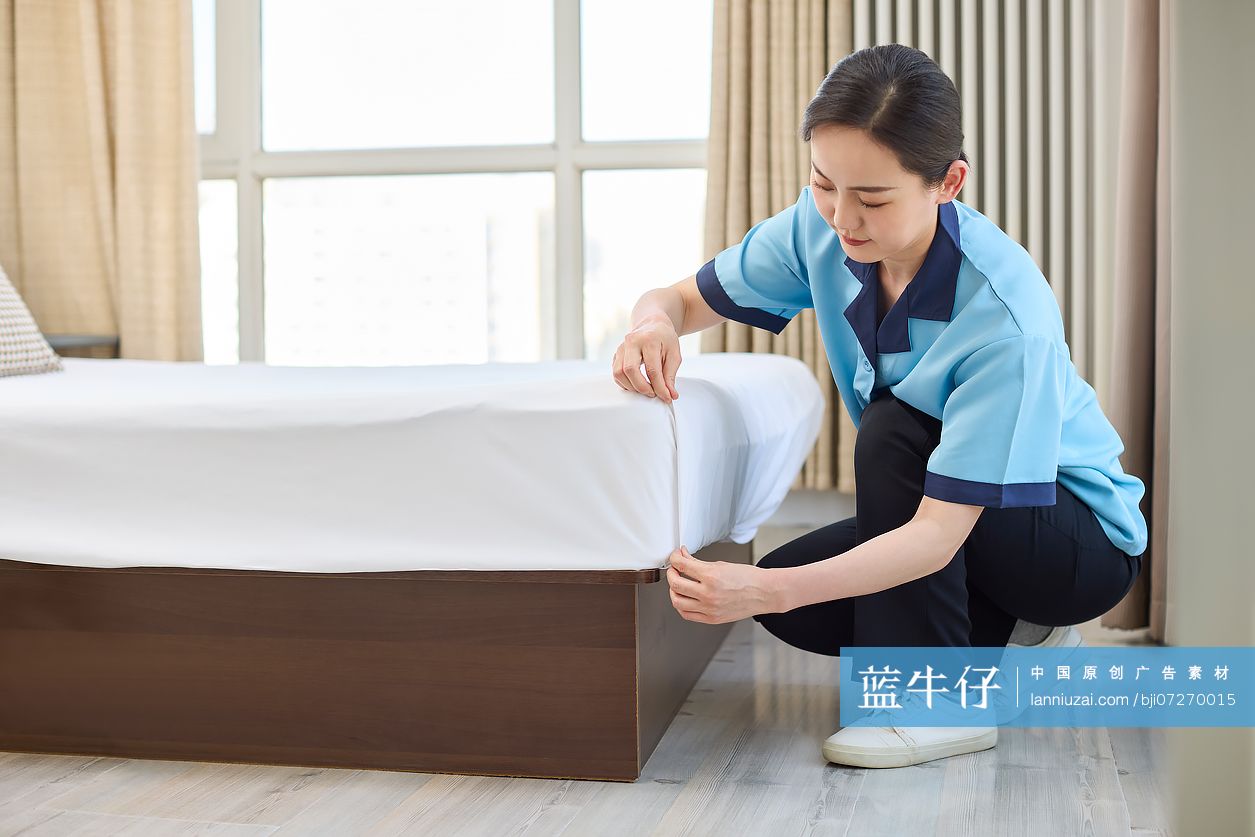 家政人员整理卧室床铺