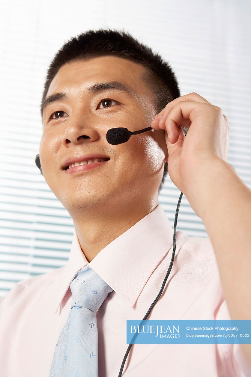 Chinese Man Wearing A Headset