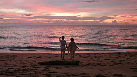 Senior Chinese couple enjoying in sunset on beach,4K