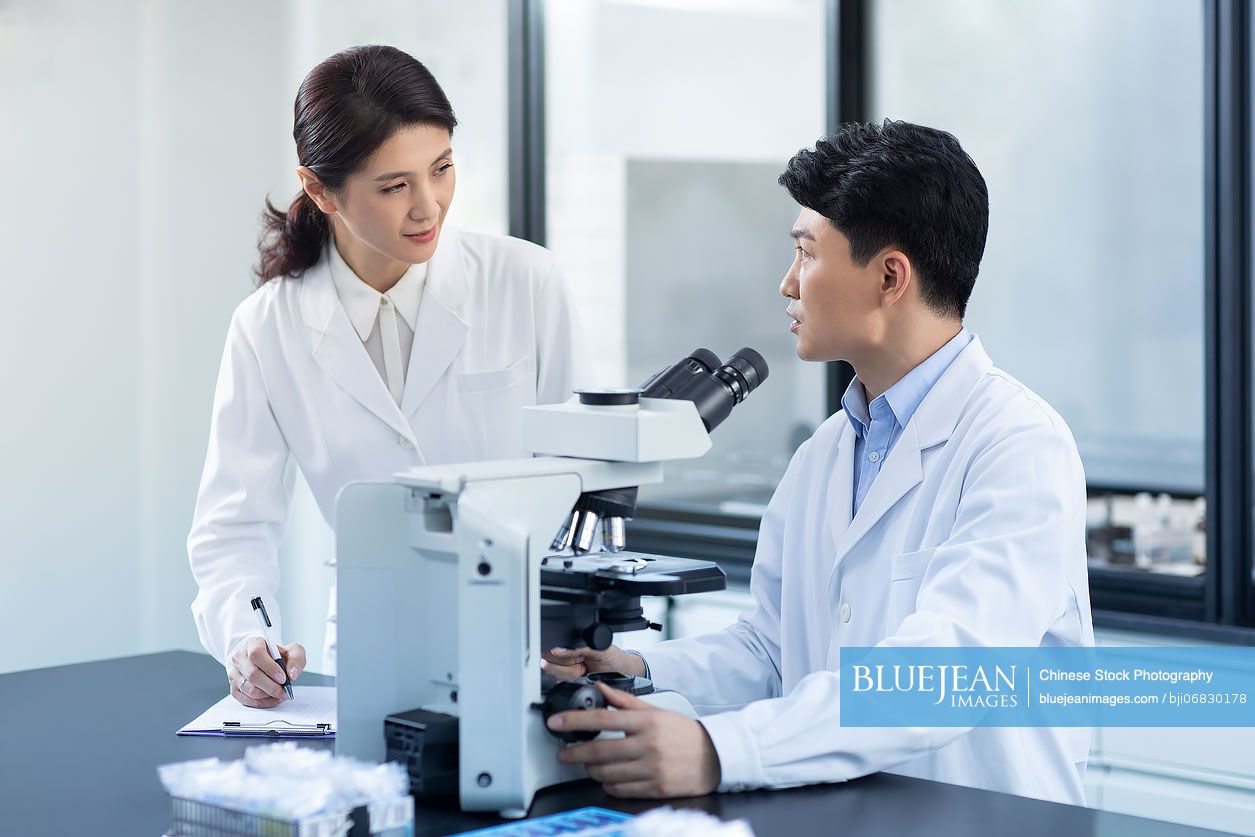 Chinese researchers discussing in laboratory