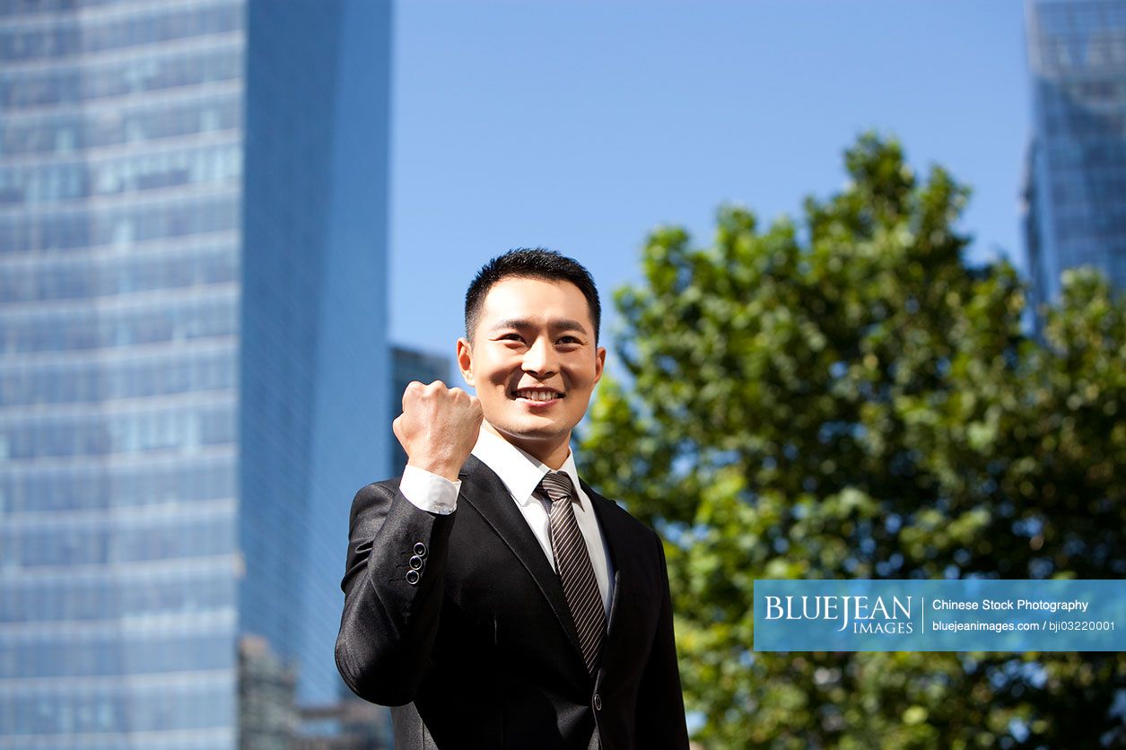 Portrait of confident Chinese businessman outdoors