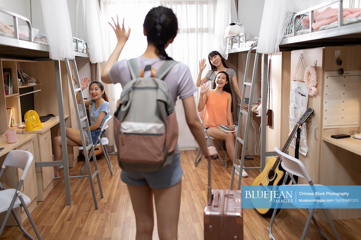 Young Chinese university student arriving at dormitory