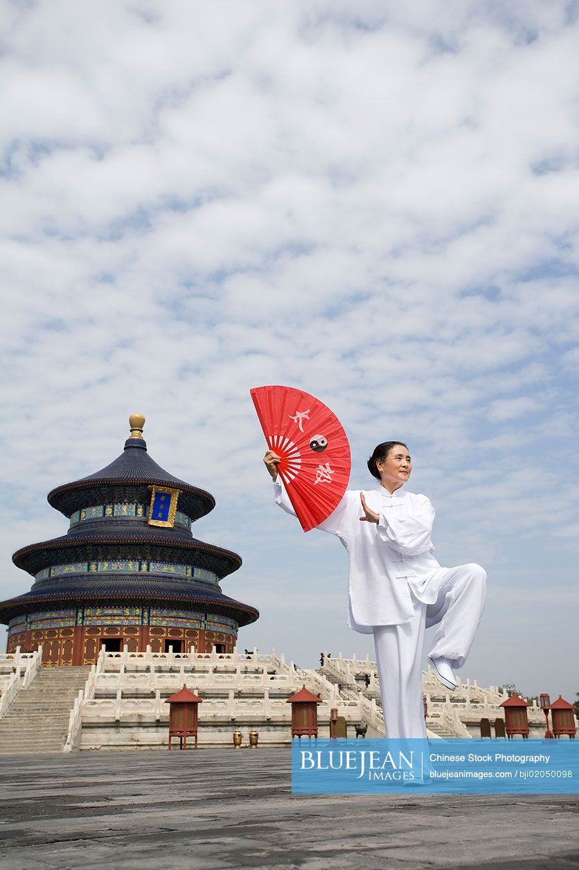 Senior Chinese woman practicing Tai Chi in Temple of Heaven