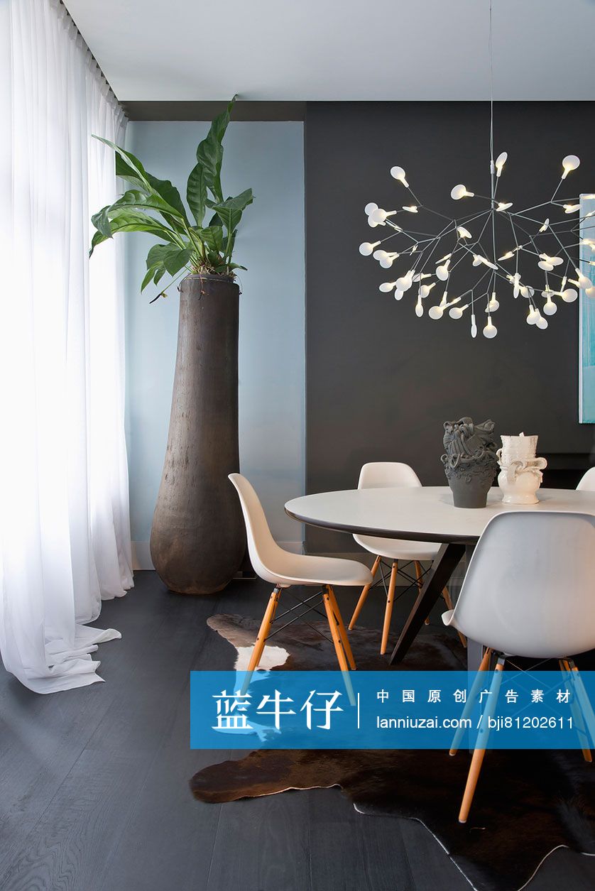 Elegant chandelier over table and chairs in modern dining room