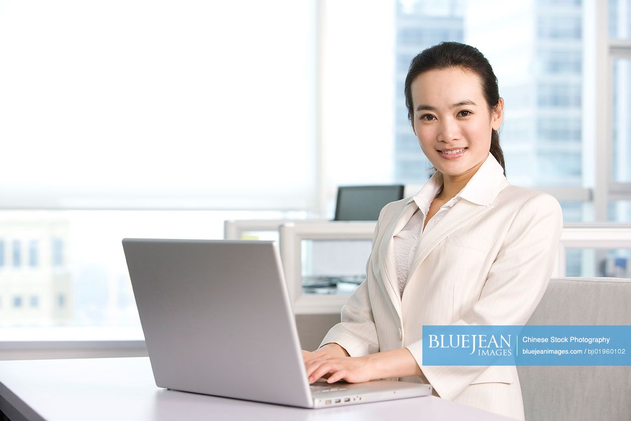 Chinese office worker using her computer