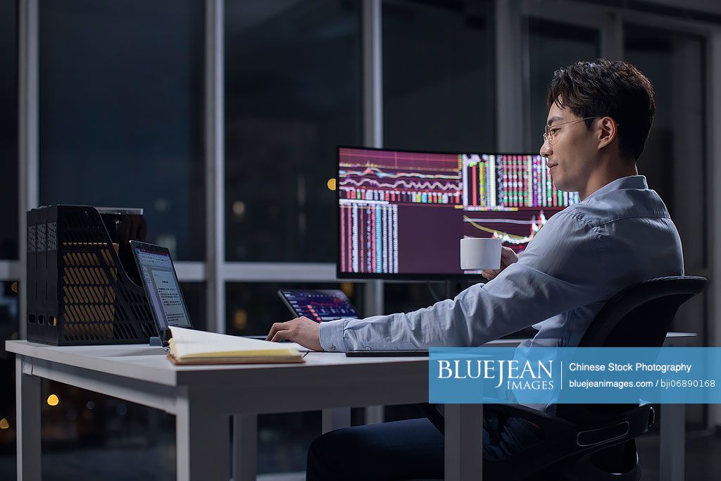 Chinese businessman working in office at night