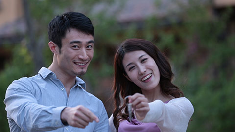 Happy young Chinese couple holding house key,HD