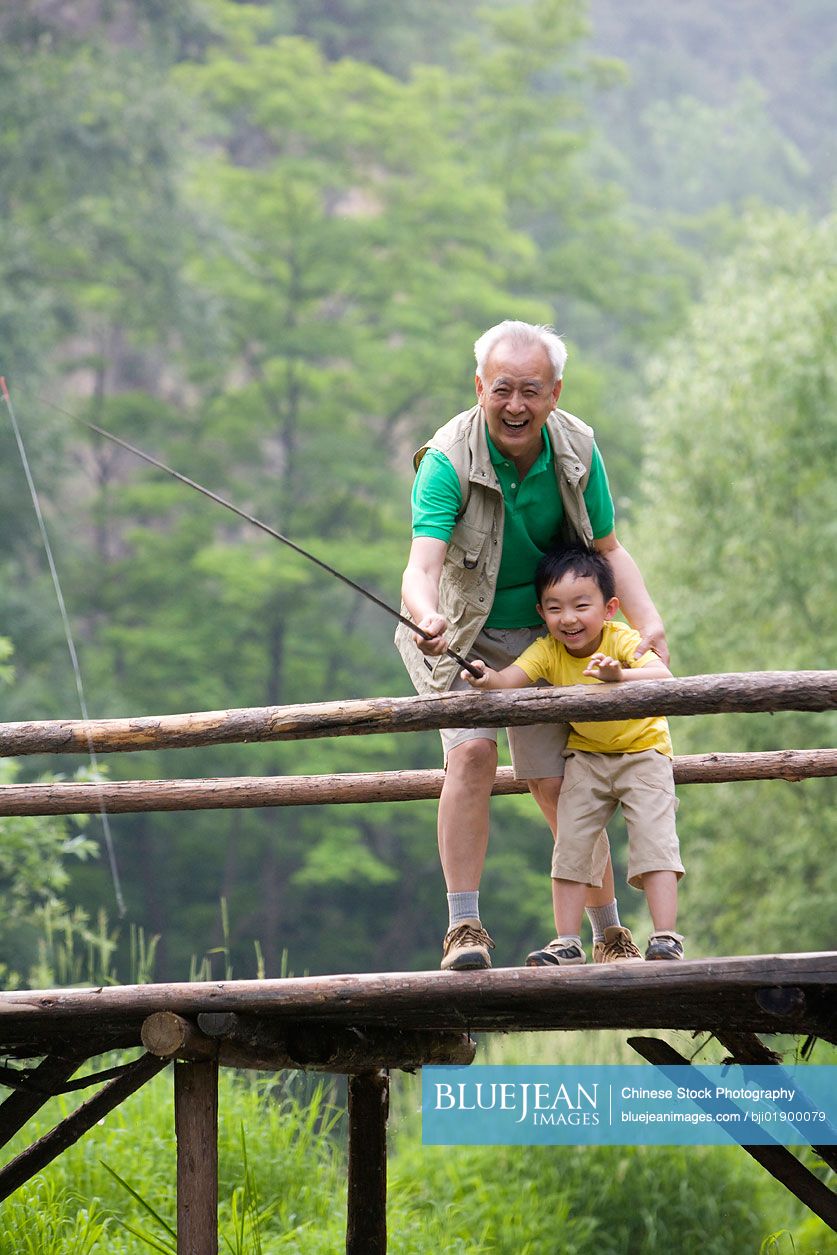 Chinese grandfather and grandson fishing