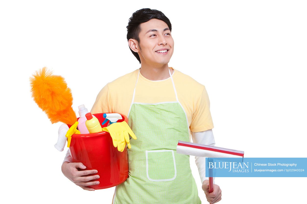 Young Chinese man with cleaning product