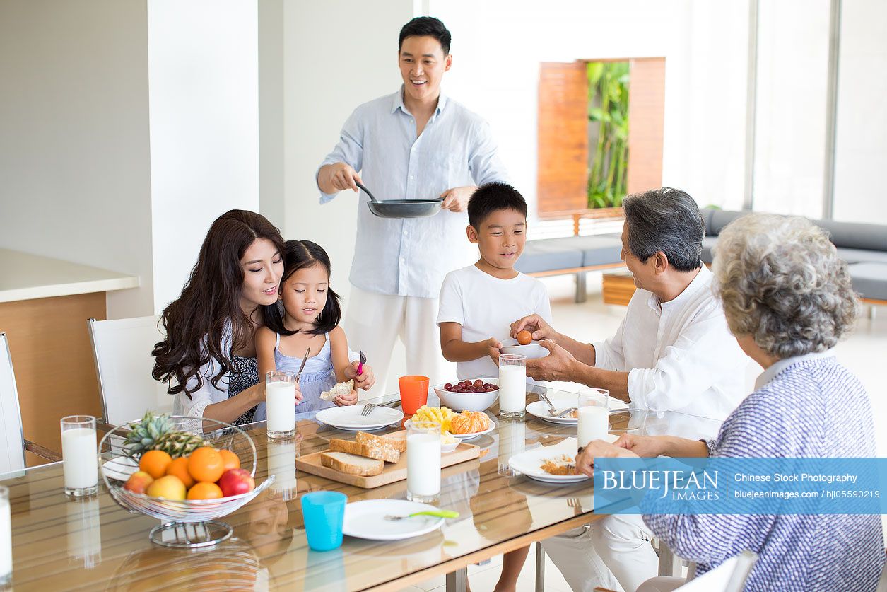 Happy Chinese family having breakfast
