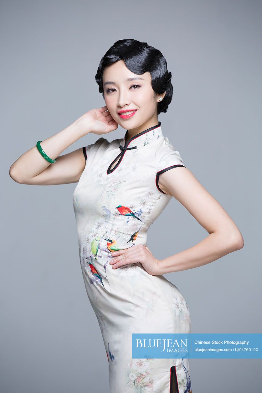Portrait of young beautiful Chinese woman in traditional cheongsam