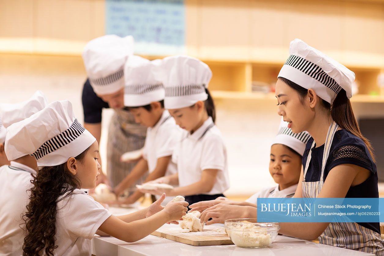 Children learning cooking in classroom