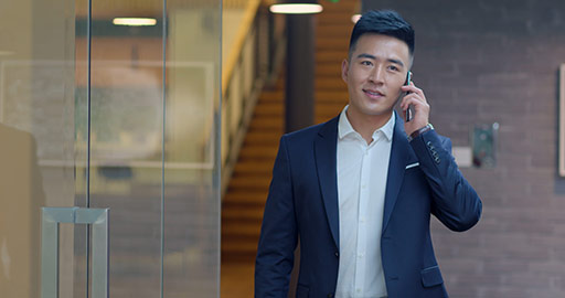 Confident Chinese businessman using smartphone in office,4K
