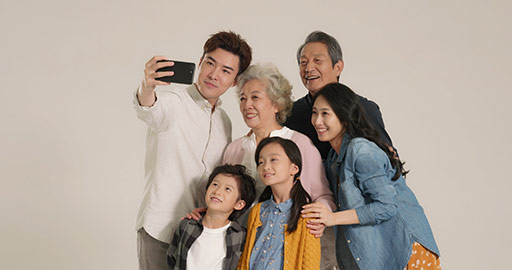 Happy Chinese family taking selfie with smartphone,4K