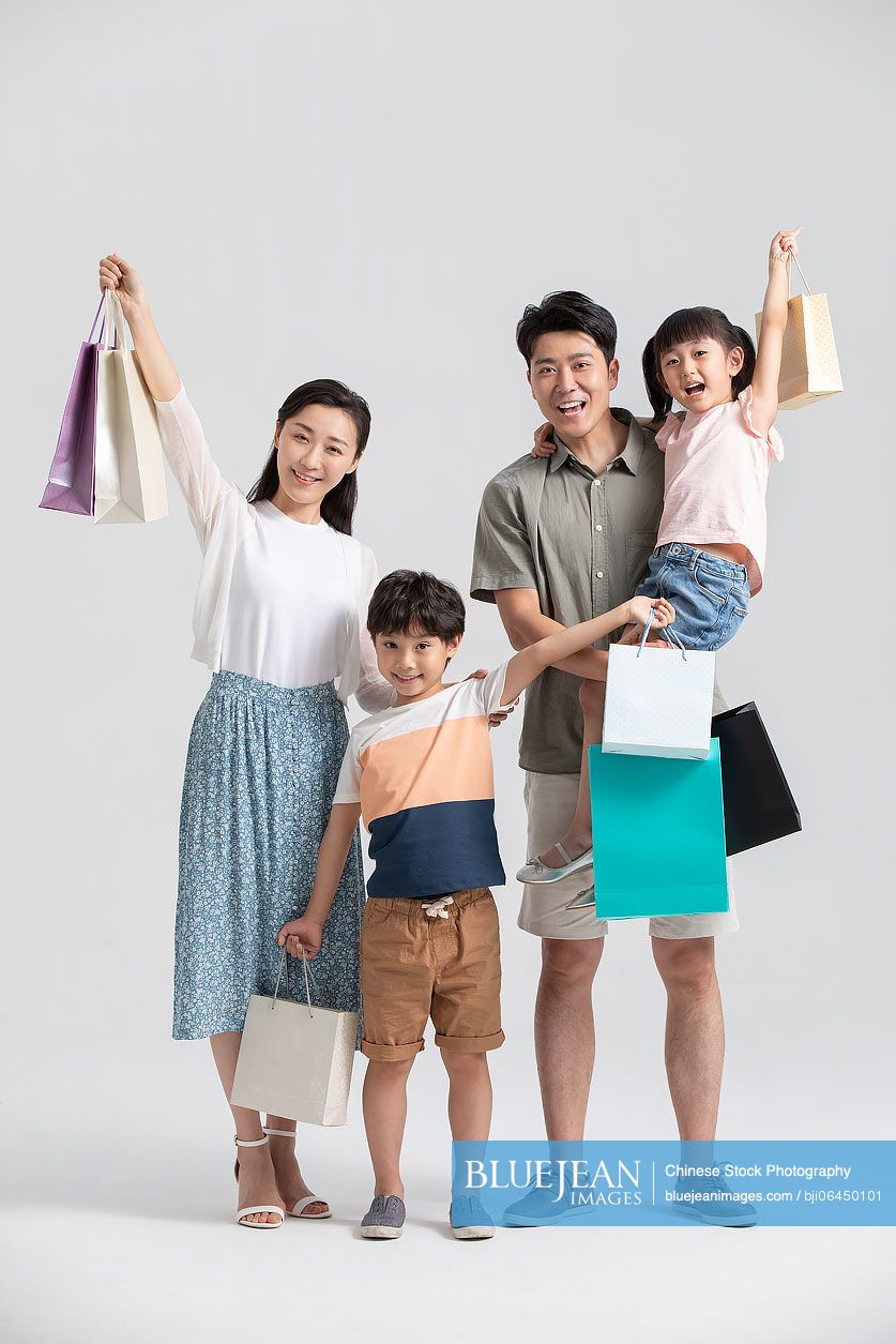 Happy young Chinese family shopping together
