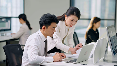 Confident Chinese business people talking in office