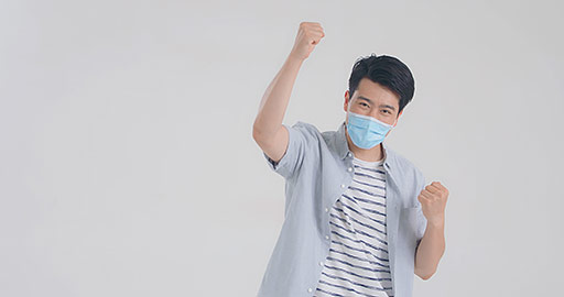 Young Chinese man with surgical mask punching the air,4K