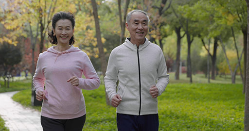 Happy senior Chinese couple running in the park,4K