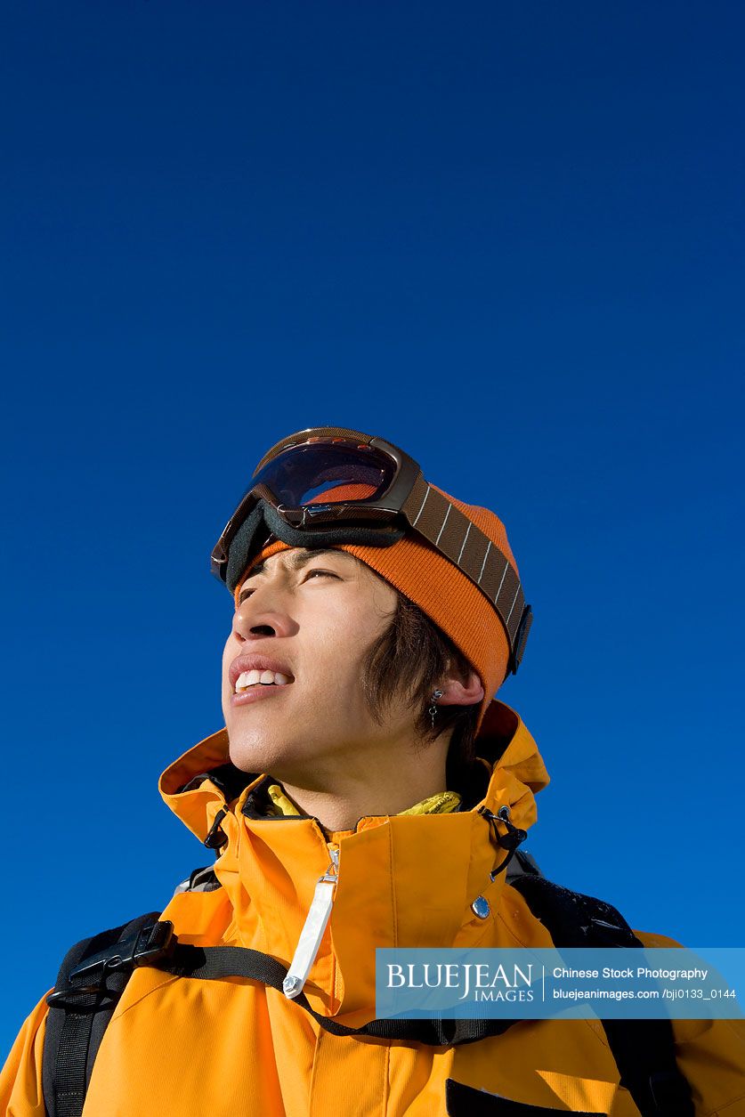 Young Chinese man in ski gear