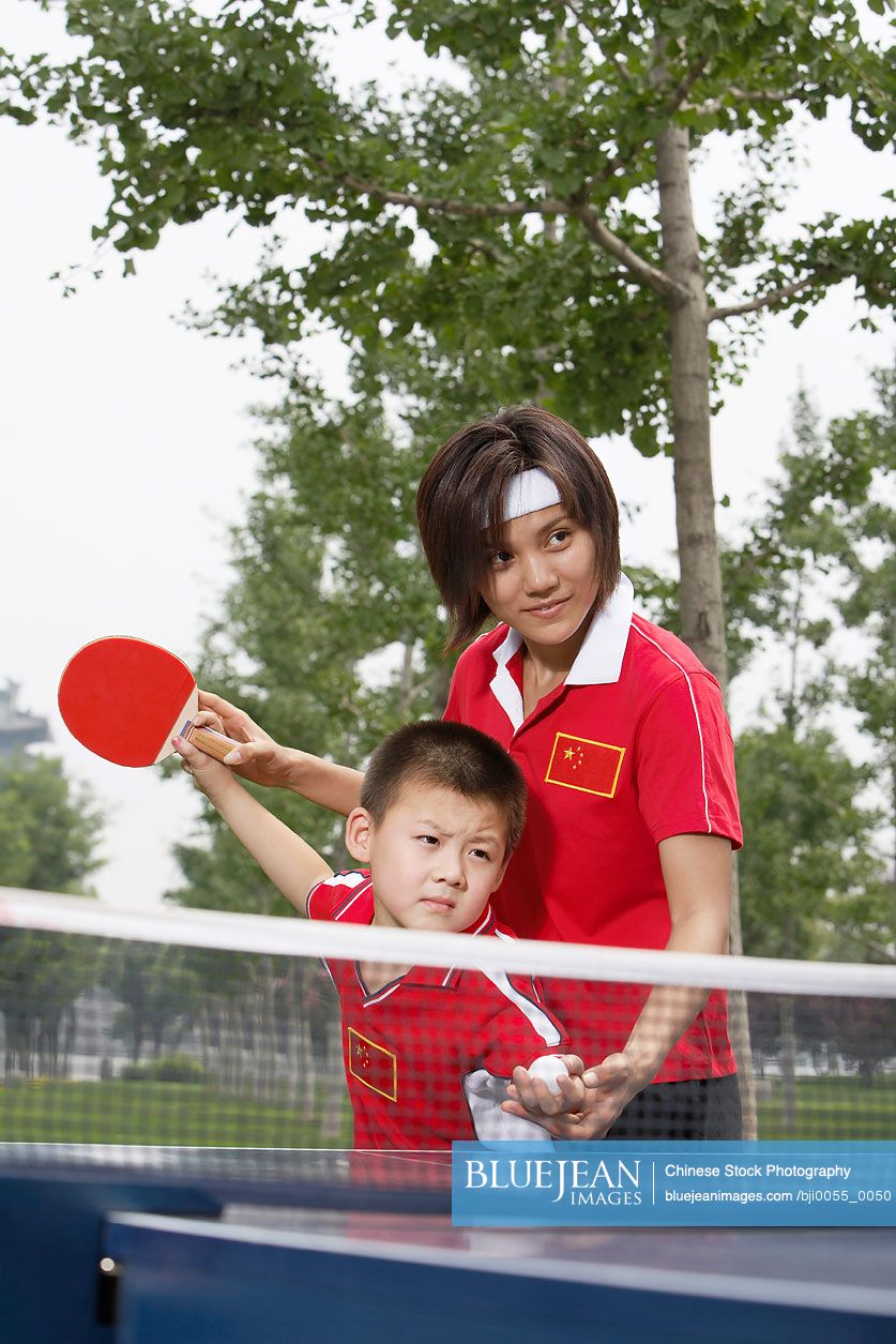 Chinese Mother And Son Playing Ping Pong