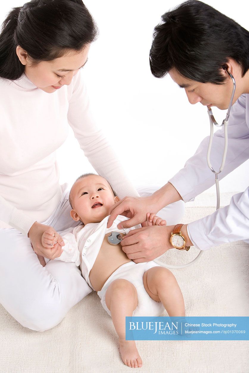 Chinese mother and infant with doctor