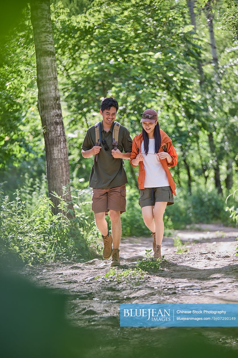 Happy couple hiking through the serene beauty of nature