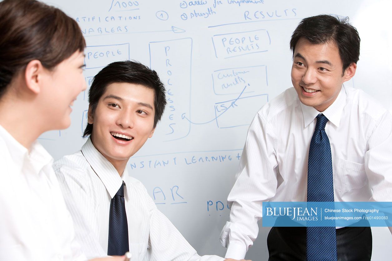 Young Chinese businessmen in meeting room