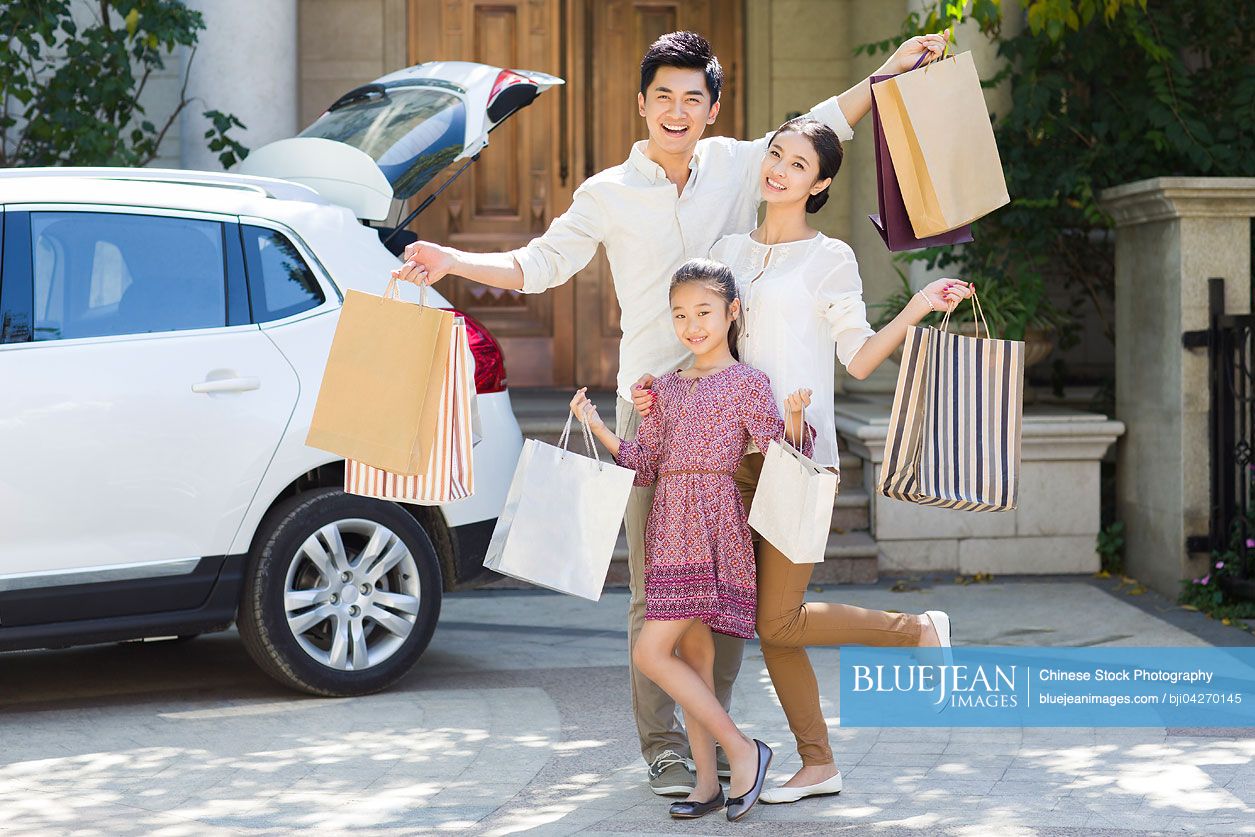 Young Chinese family coming back from shopping