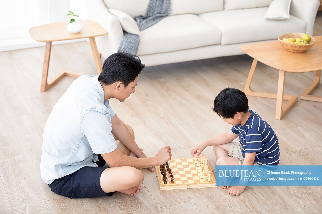 Chinese father and son playing chess