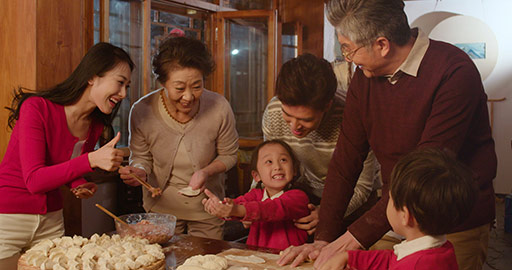 Happy Chinese family making dumplings at home,4K