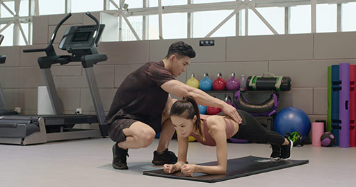 Young Chinese woman working out with personal trainer at gym,4K