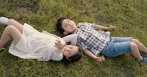 Happy Chinese children lying on the grass,4K