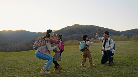 Happy young Chinese family having fun outdoors