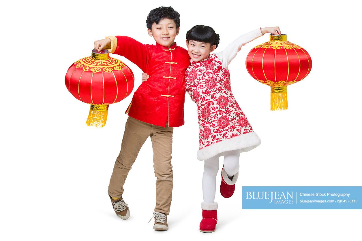 Happy children celebrating Chinese new year with traditional lanterns